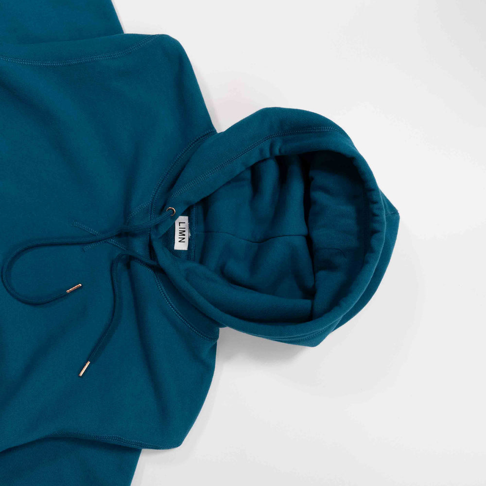 Sapphire Blue hoodie laid flat on white background.