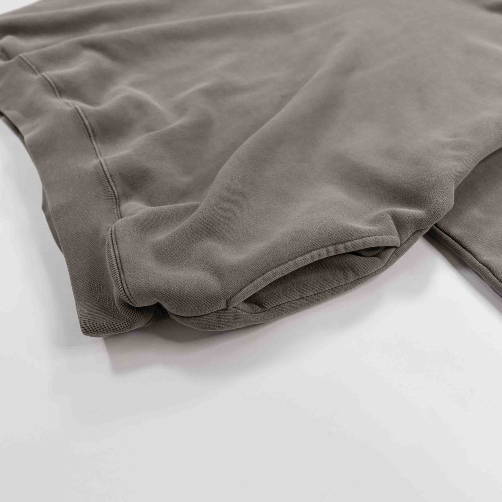 Gray round hoodie laid flat on a white surface.