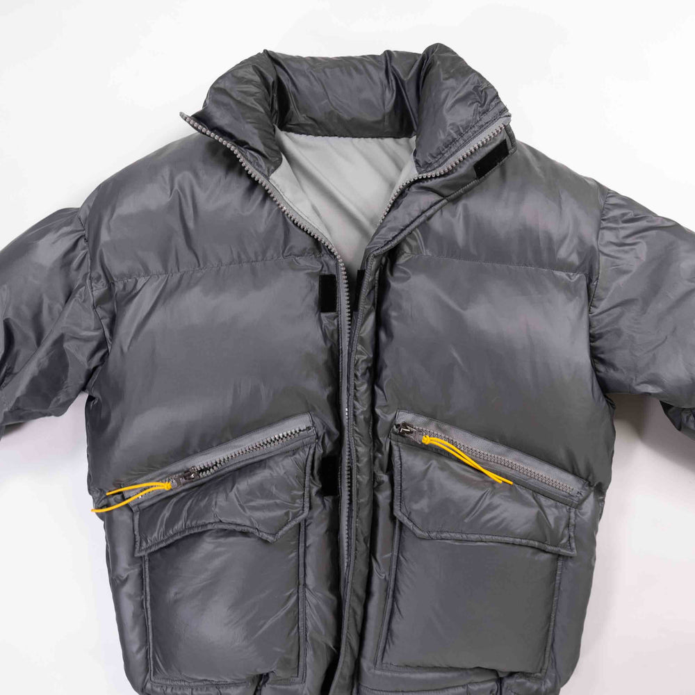 Gray padded round jacket with zippers and pockets.