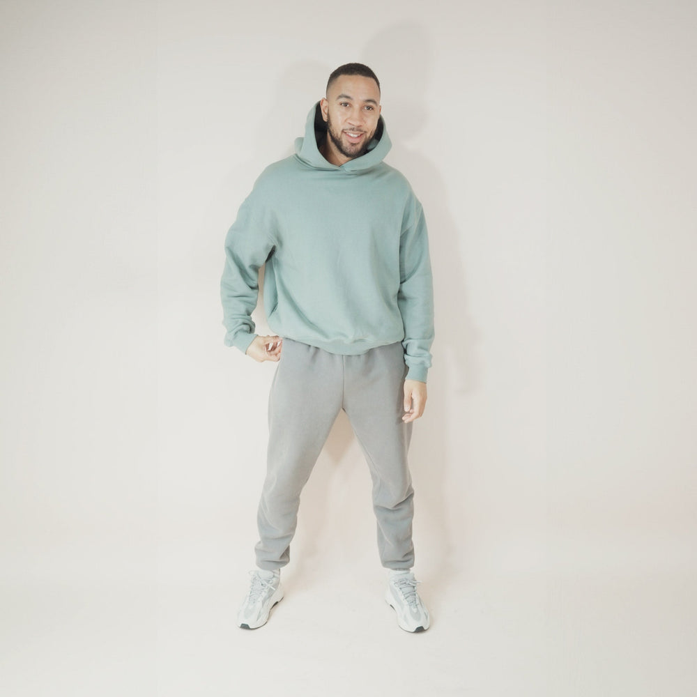 Man wearing an Aqua Round Hoodie.