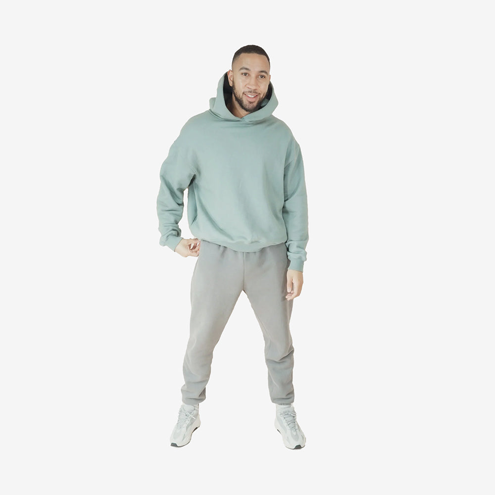 Man wearing an Aqua Round Hoodie.