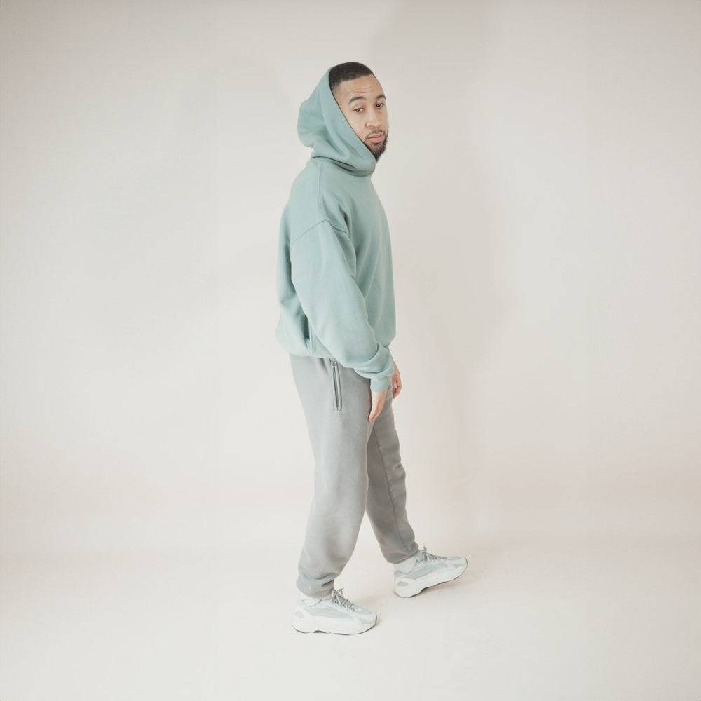 Man wearing Aqua Round Hoodie, stylish and comfortable.