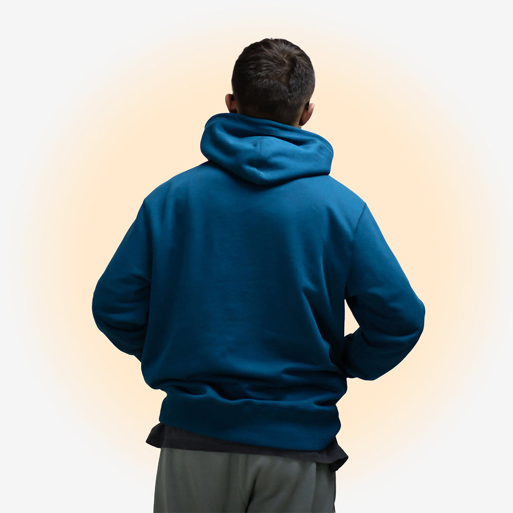 Man wearing Sapphire Blue hoodie from the back.