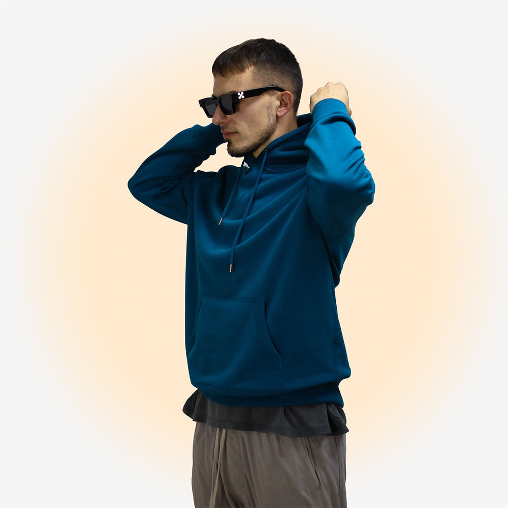 Man wearing Sapphire Blue hoodie with black sunglasses.