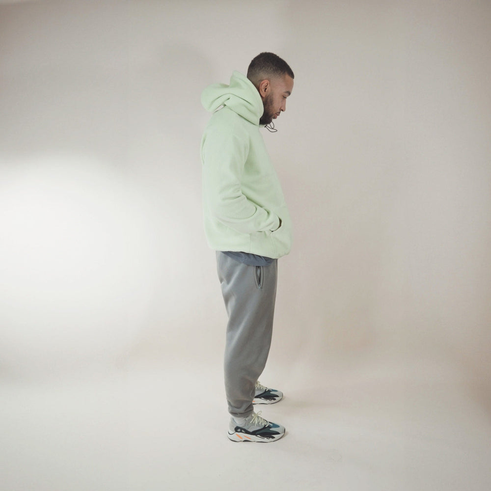 Man wearing a cozy fleece lined hoodie in a neutral setting.