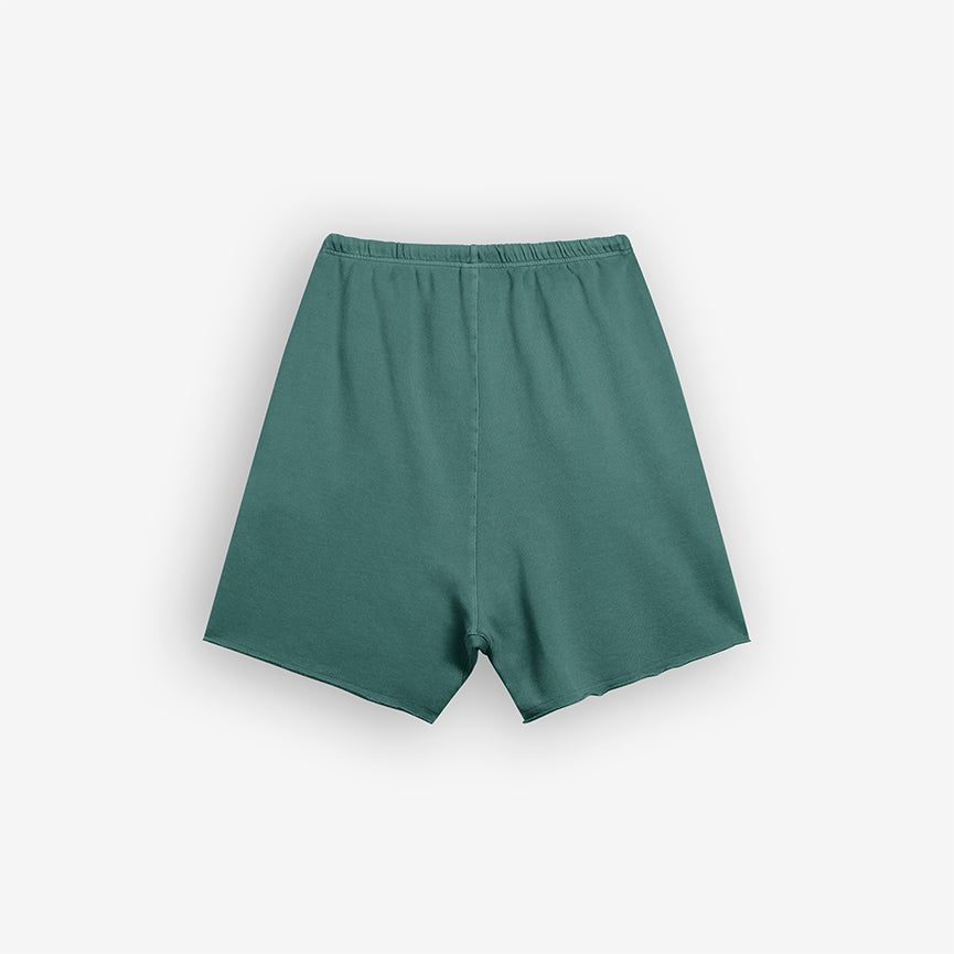 Raw Edge Limn Teal Shorts – Back View, Plain Teal Shorts with Raw Edge on Off-White Background with Shadow