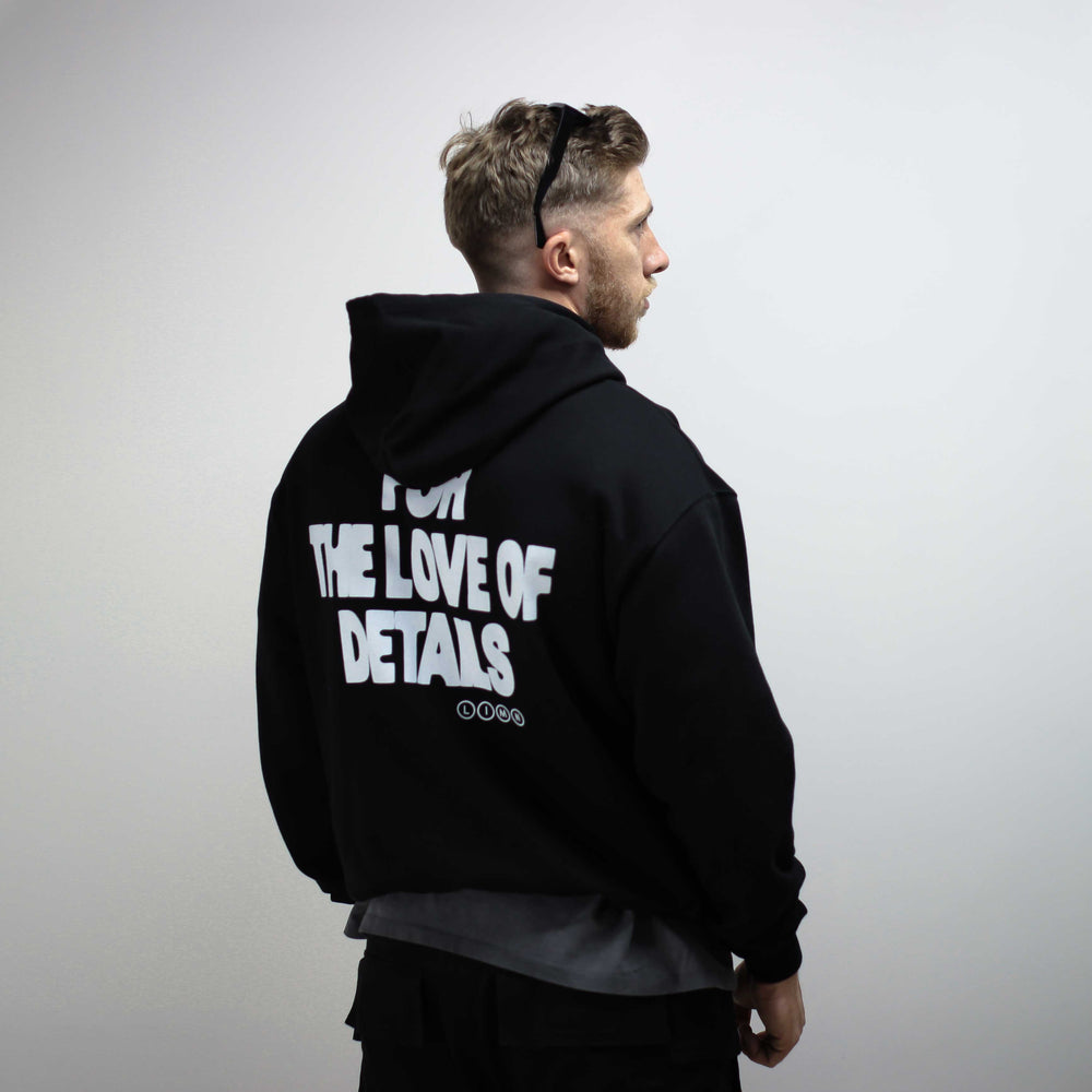 Black hoodie with "For the Love of Details" printed on the back.