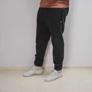 model shot of premium core gray jogging pants, cream yeezy calabasas power phase on foot, wearing copper t-shirt