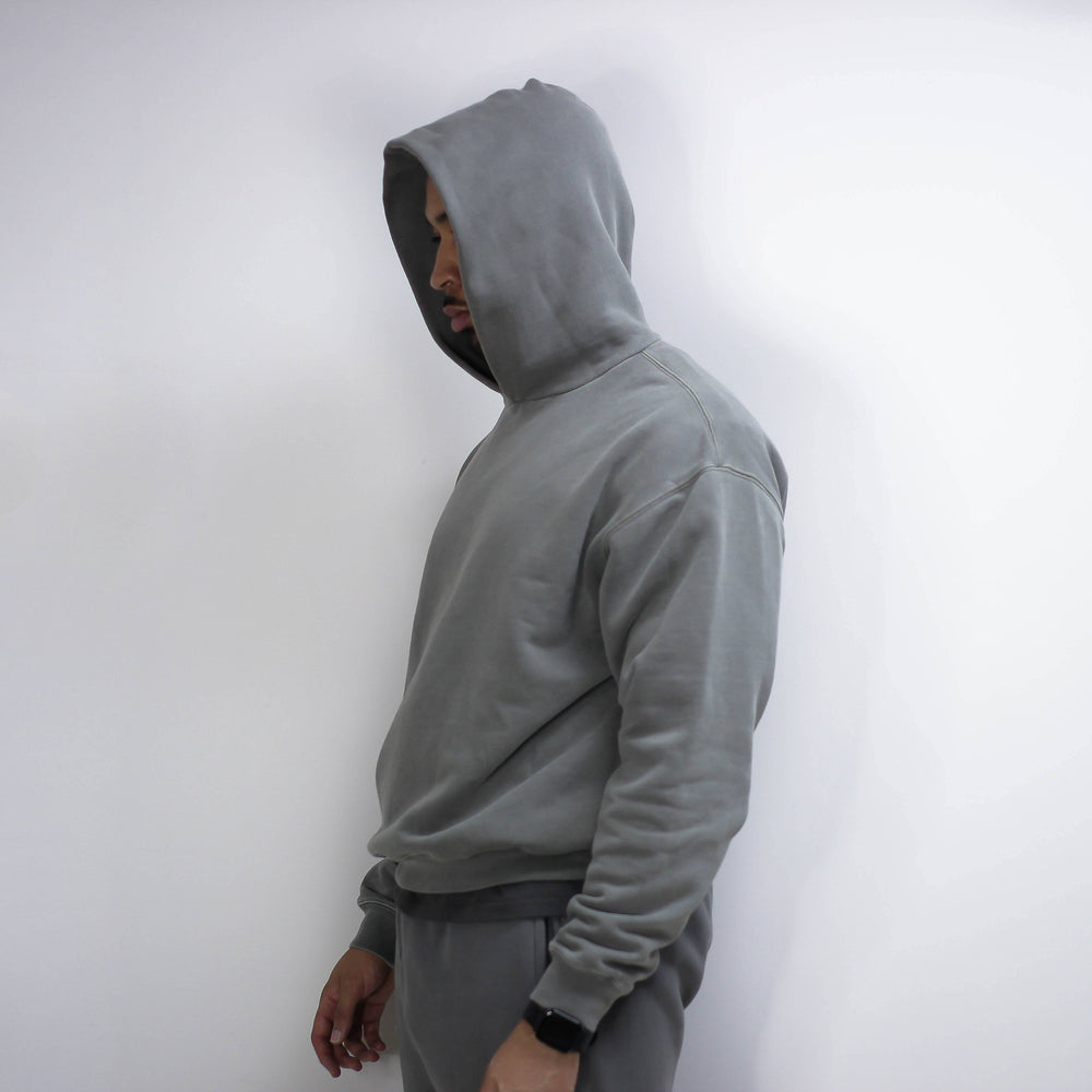 Gray round hoodie worn by a person.