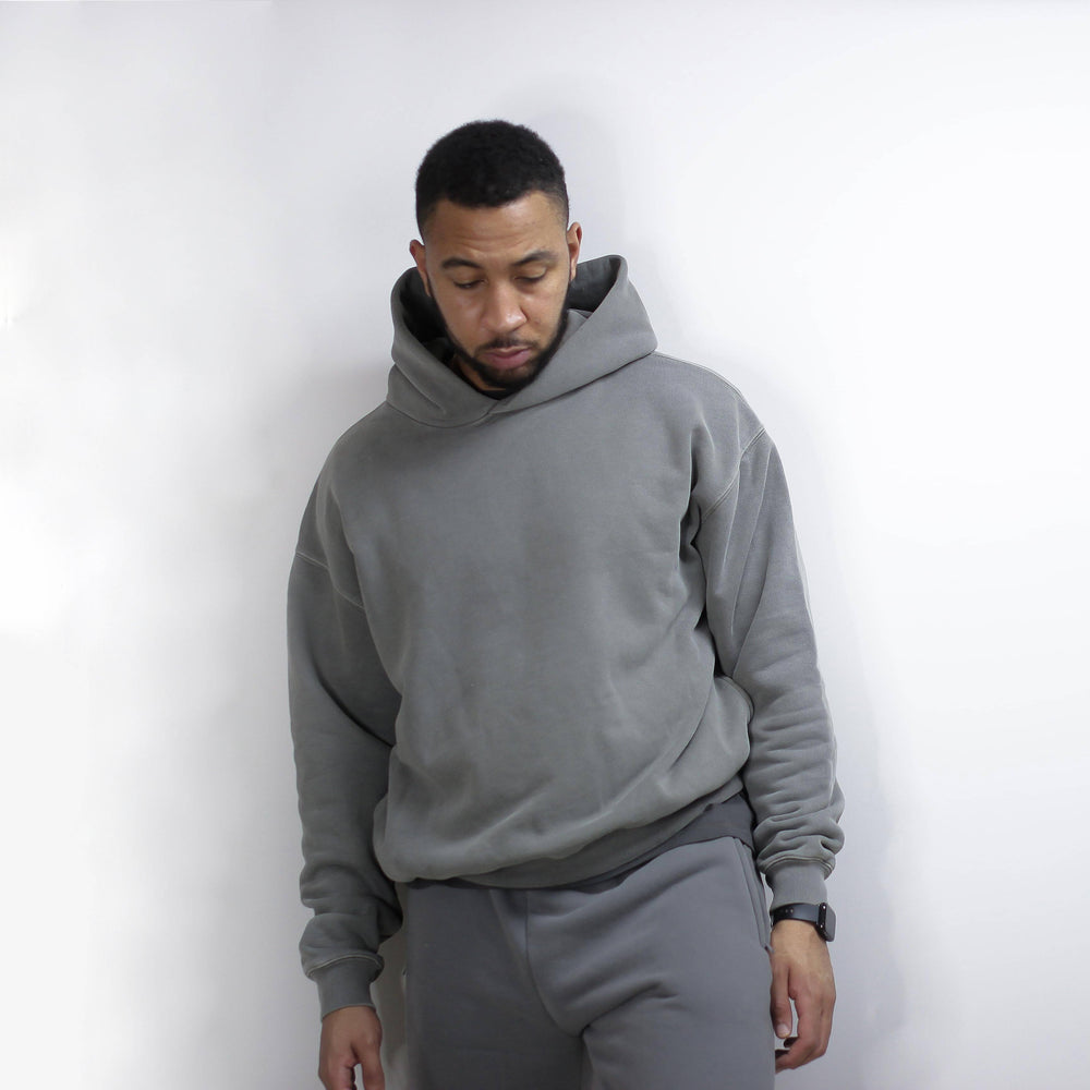 Man wearing a gray round hoodie.