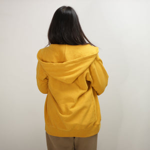 back shot of women wearing Amber Orange zip-up hoodie designed for all seasons