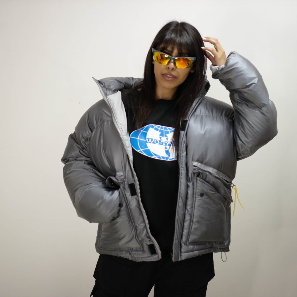 Padded Round Jacket in gray worn by model with sunglasses.