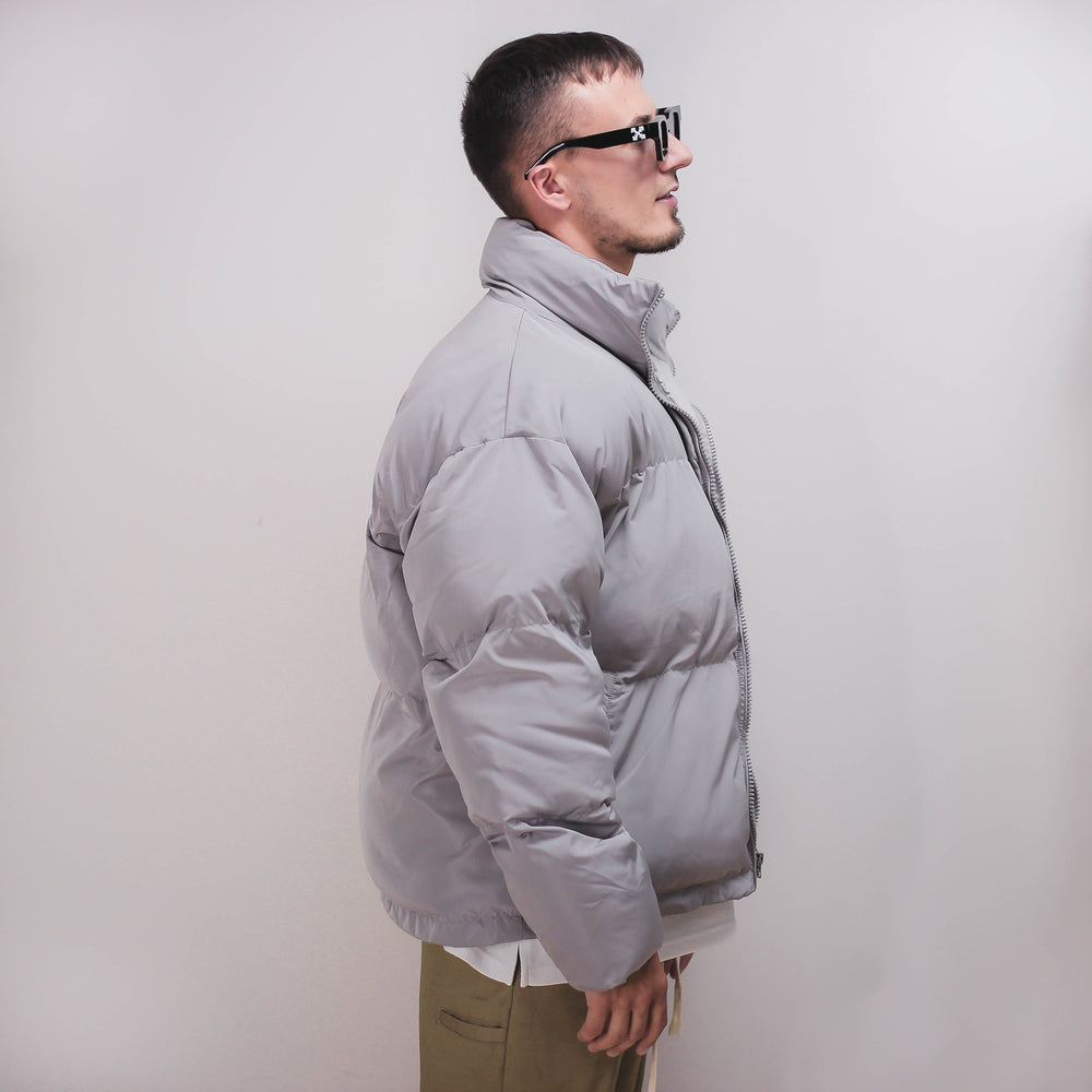 Man wearing a gray puff jacket.