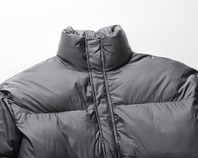 Padded round jacket in dark grey color.