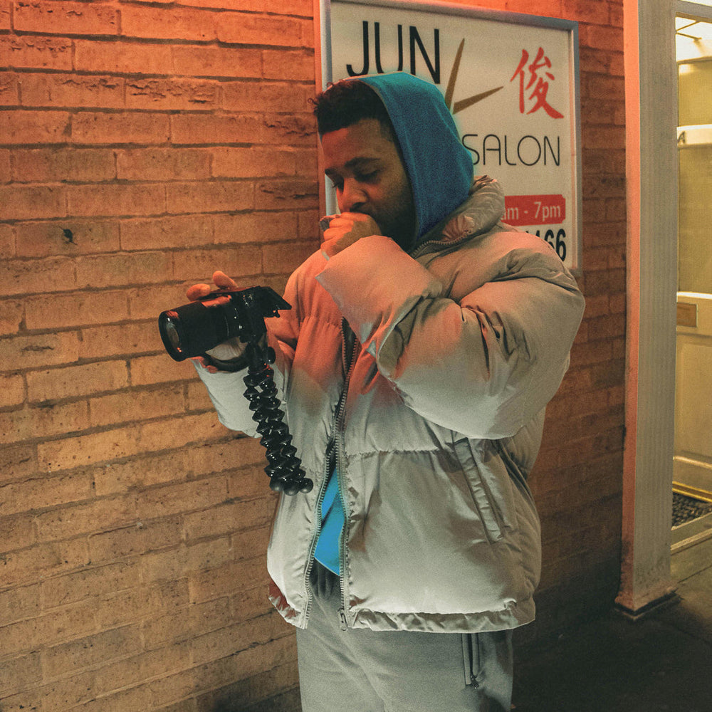 Man wearing puff jacket outdoors at night.