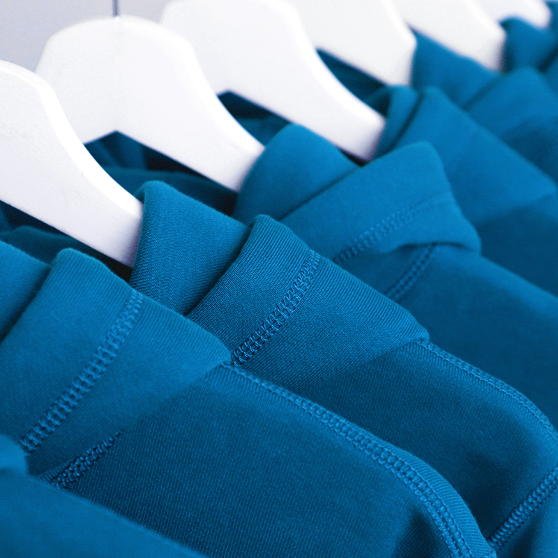 Sapphire Blue hoodie hanging on a rack.