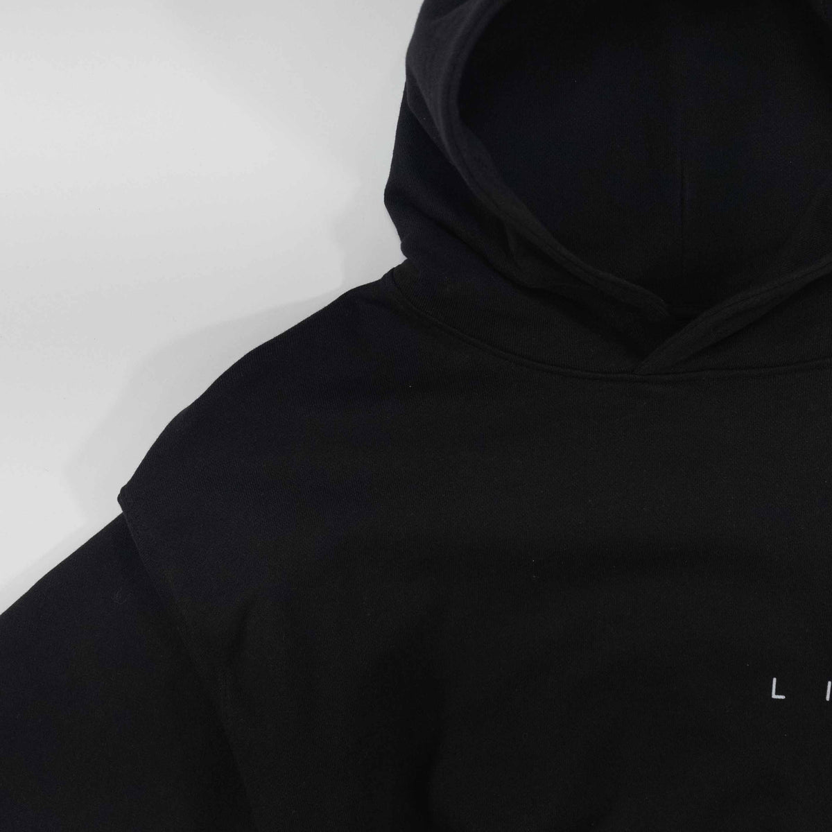 Black details hoodie with minimalist design.