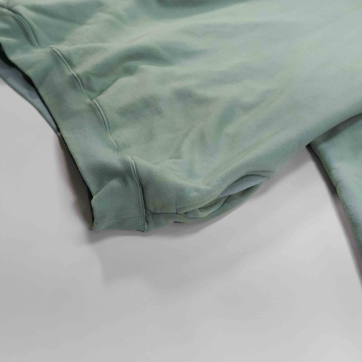 Aqua Round Hoodie featuring a soft, pastel green fabric.