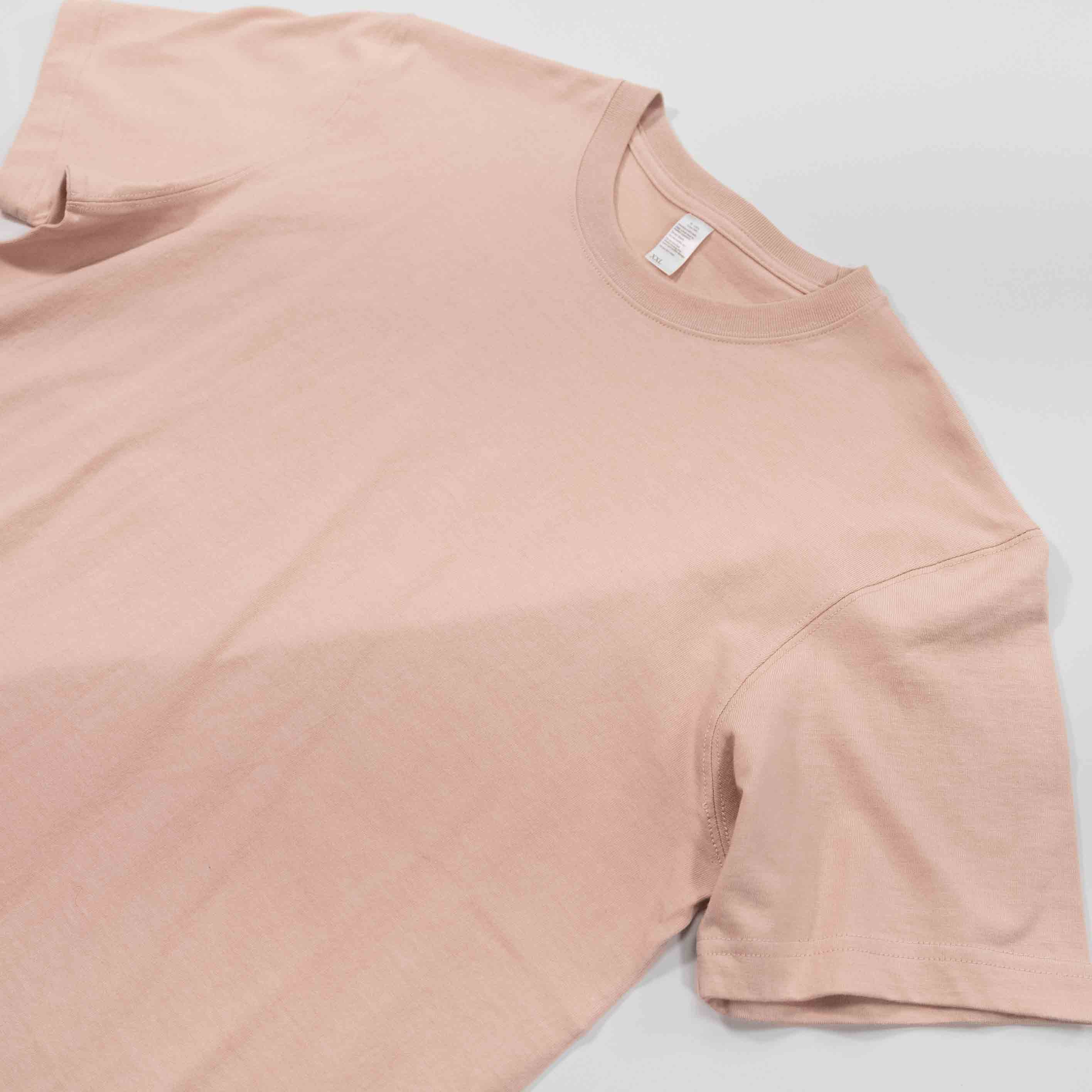 Peach Winter Tee laying flat on a surface.