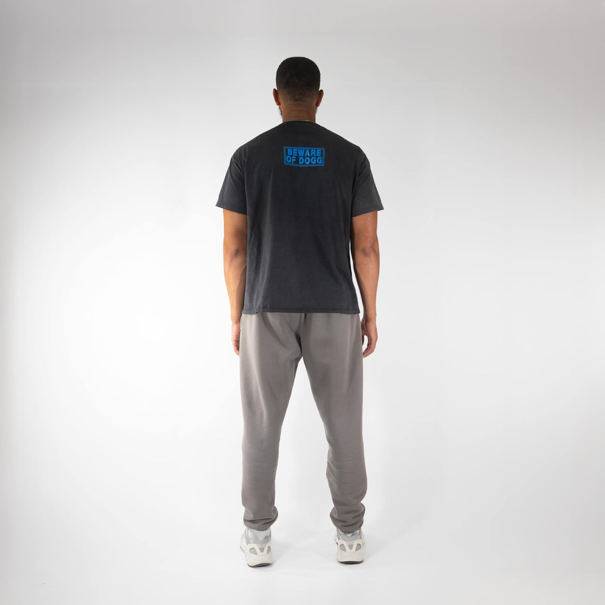 Man wearing light gray premium jogger, back view.