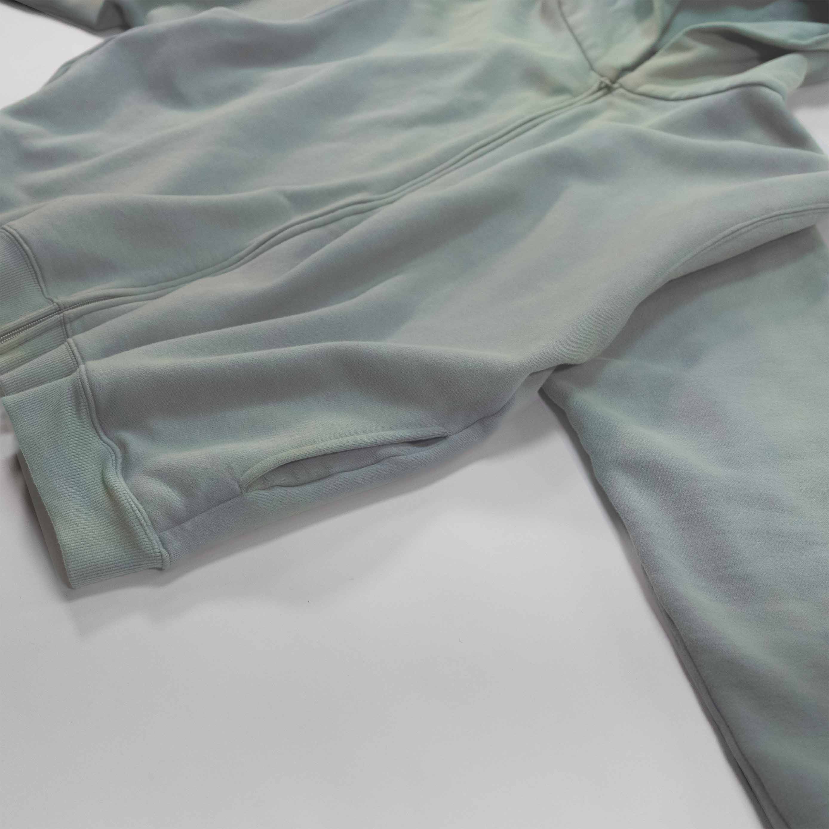 Aqua Zip-up Hoodie lying flat on a white surface.