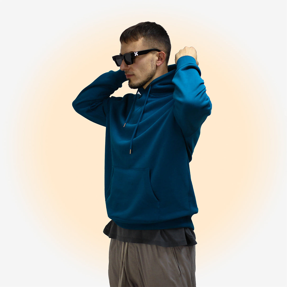 Man wearing Sapphire Blue hoodie with black sunglasses.