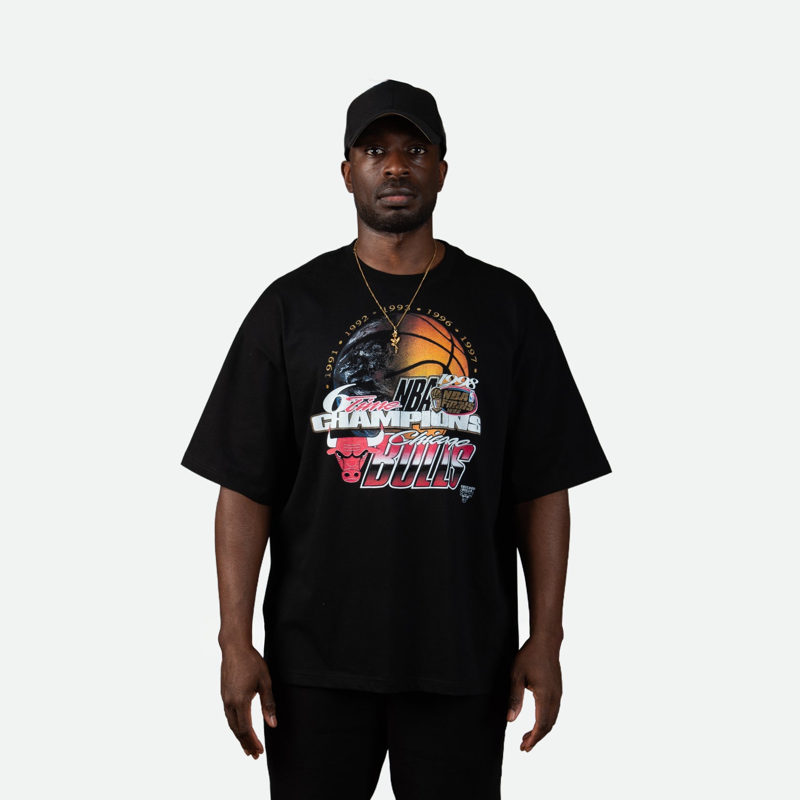 Man wearing a black t-shirt with sports-themed graphic on a white background