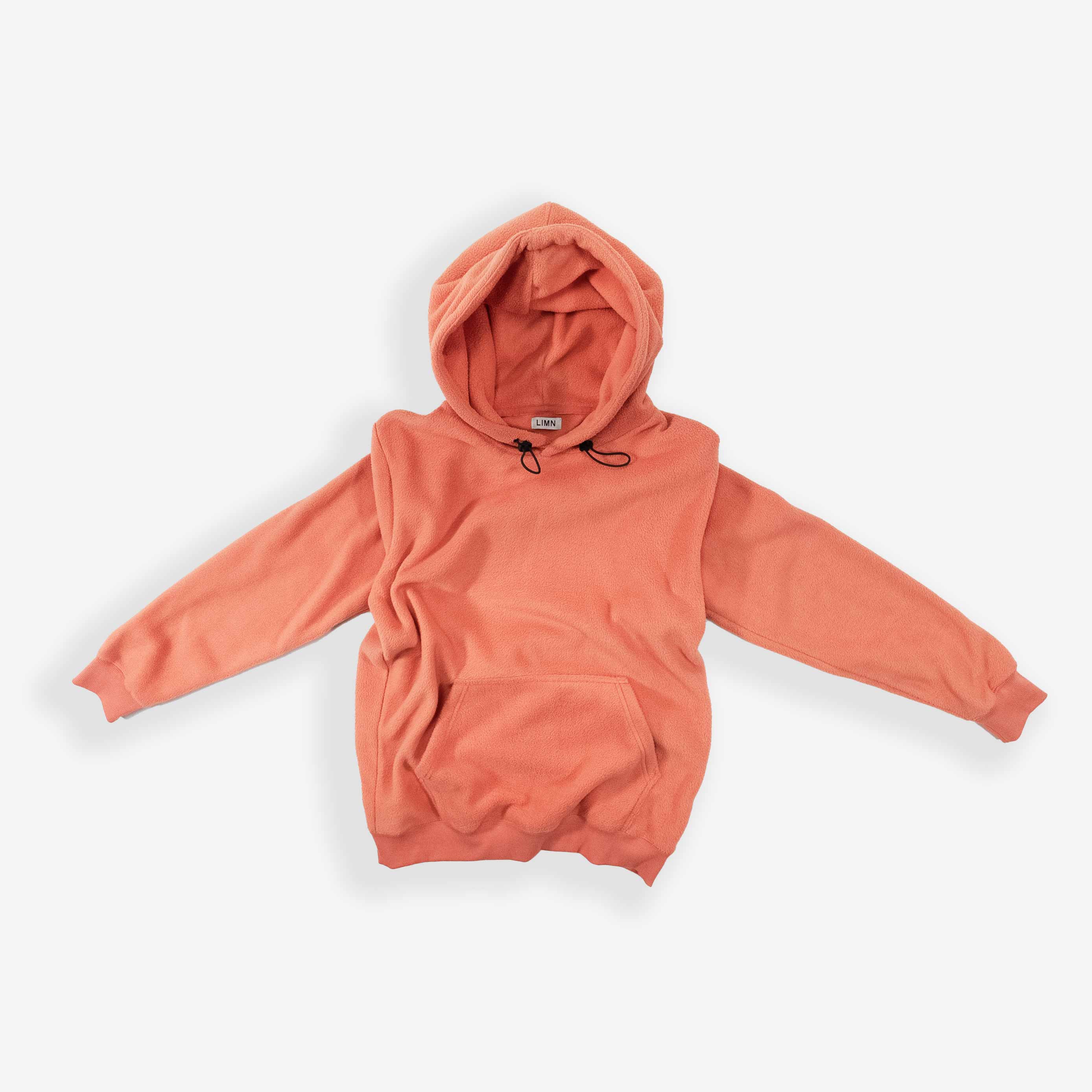 Cozy Peach Hoodie laid flat with drawstring hood and front pocket