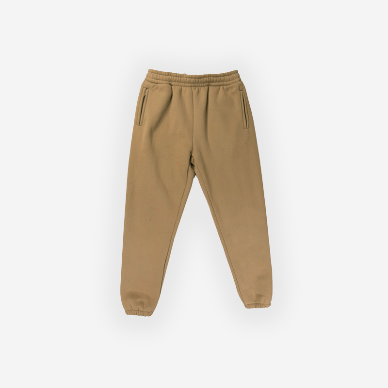 Tan premium joggers with elastic waistband and zippered pockets.