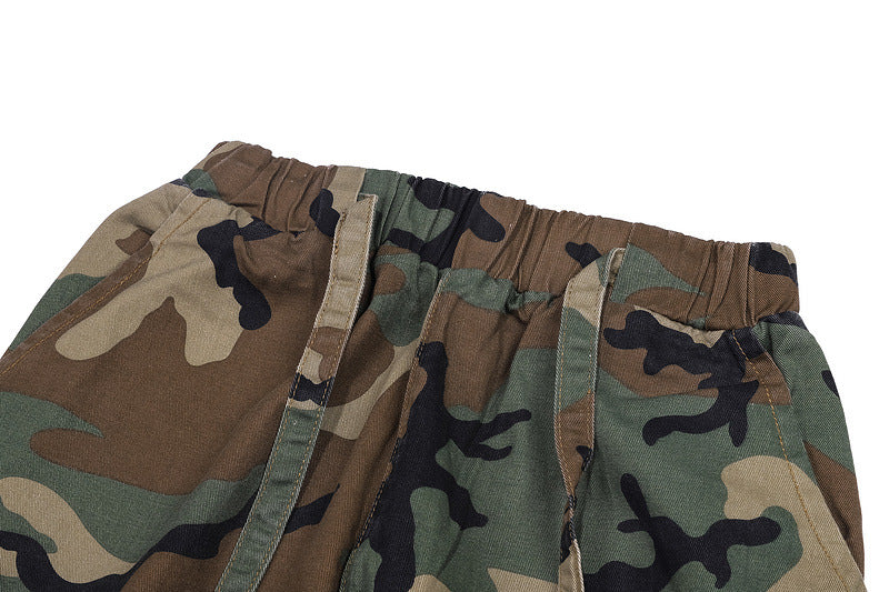 Close-up of camo trousers with elastic waistband.
