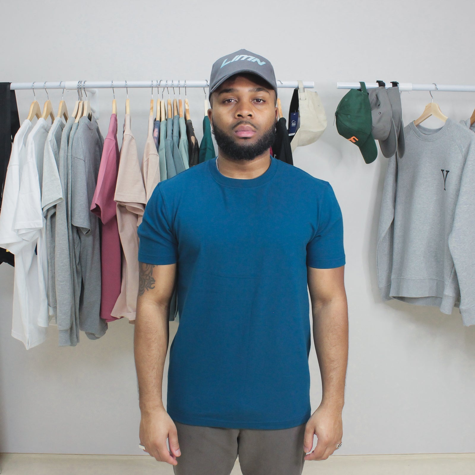 Man wearing Sapphire Blue Winter Tee in clothing store.