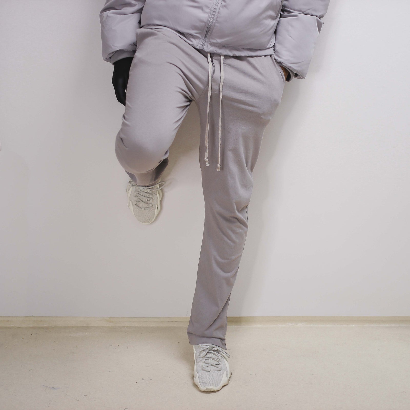 Grey drawstring pant on white background.