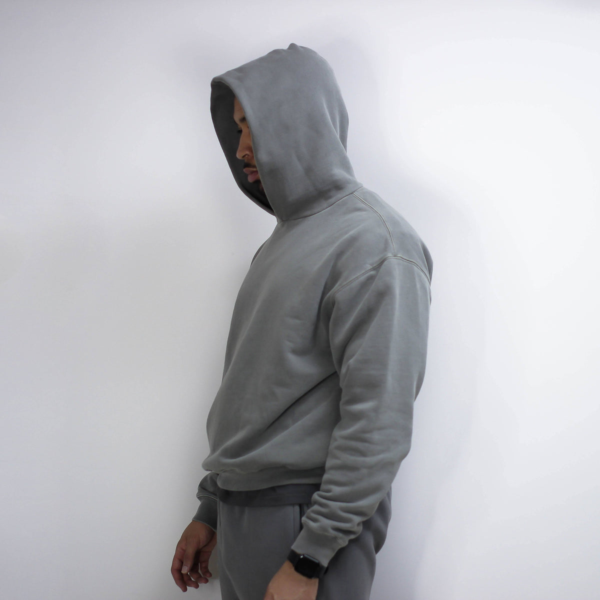 Gray round hoodie worn by a person.