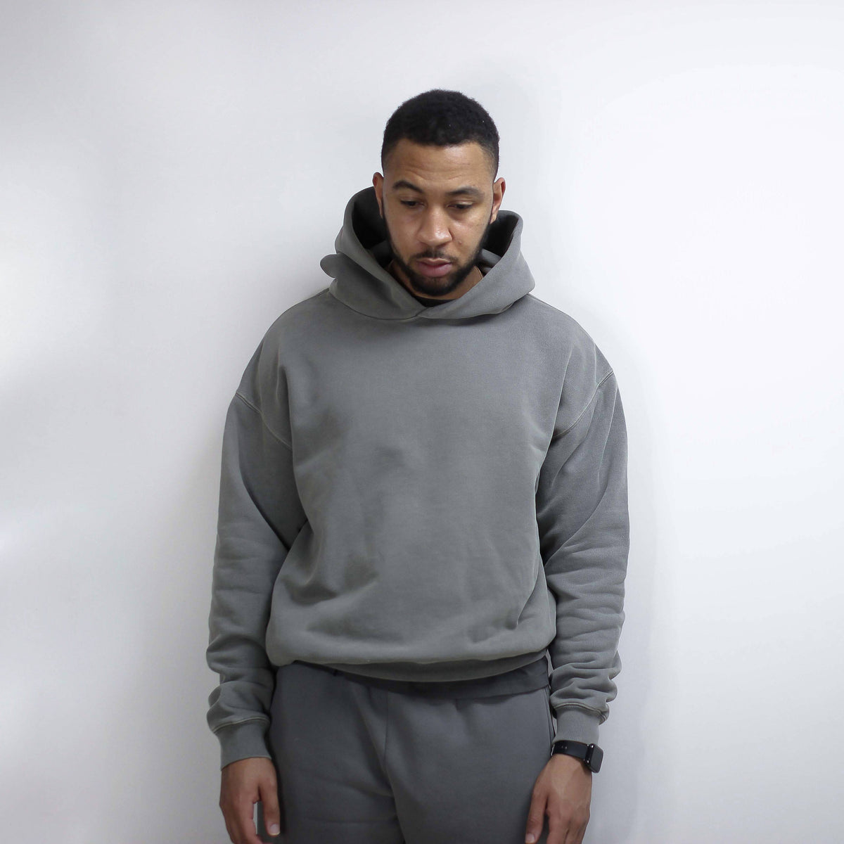 Gray Round Hoodie worn by a person against a white background.