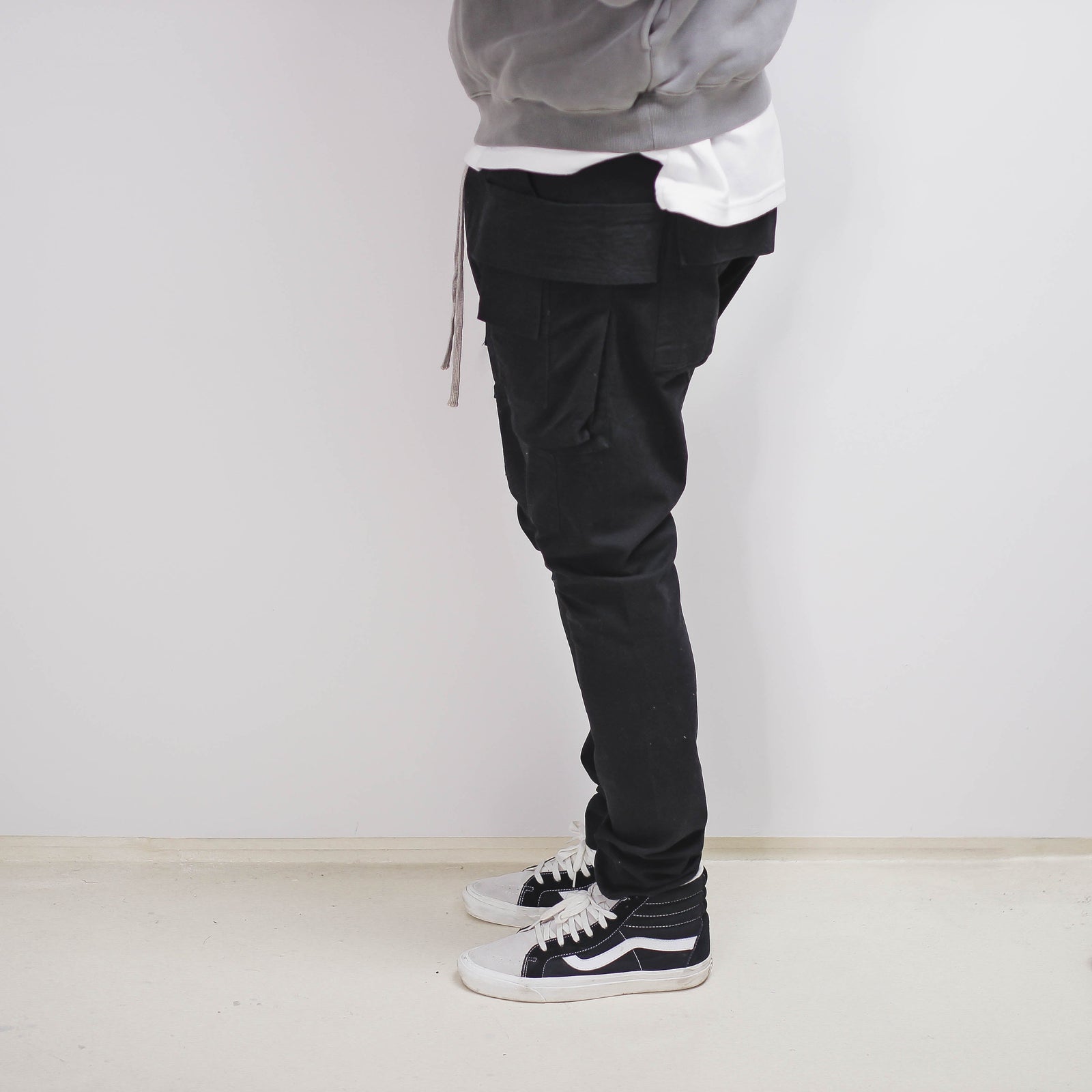 Black slim cargo pant with drawstring and side pockets.