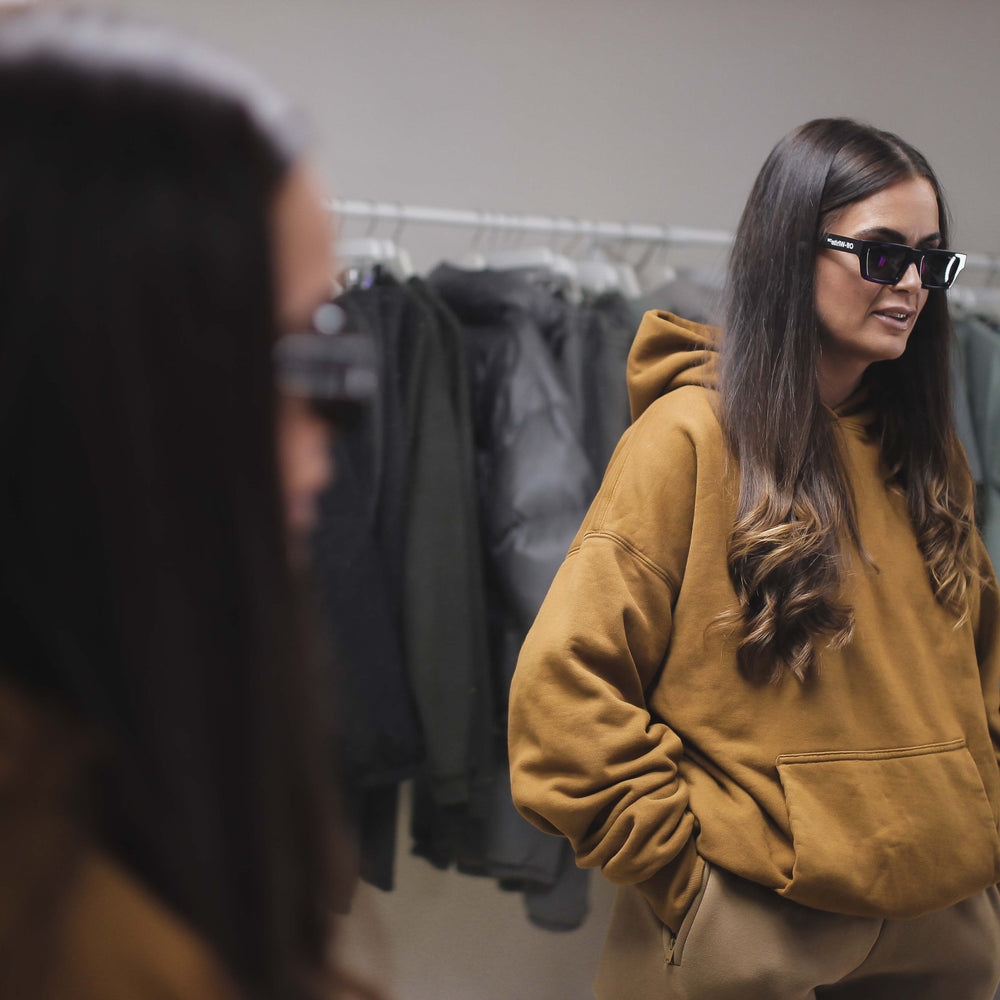 Double Layer Hoodie worn by a woman in a store setting.