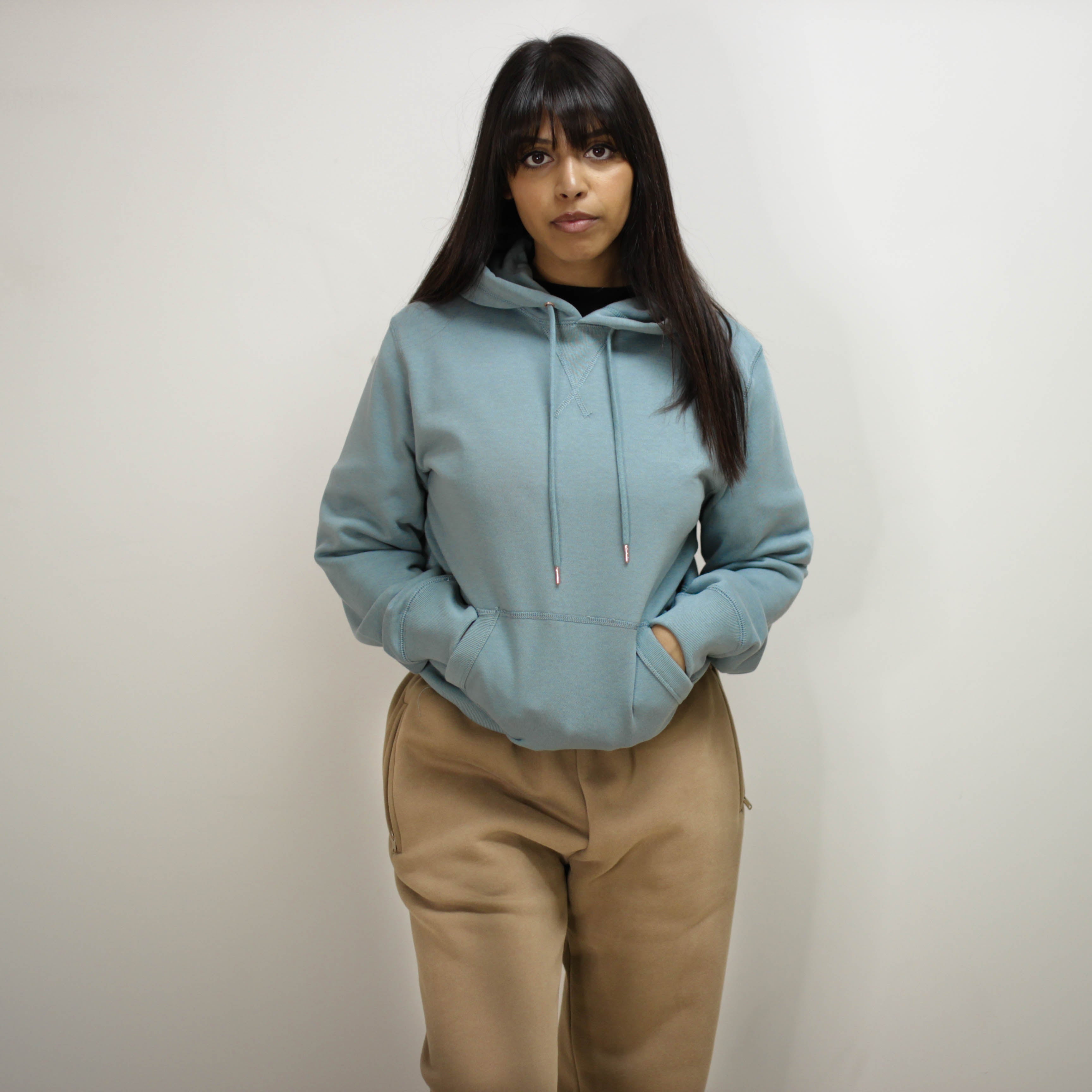 Woman wearing Azure Blue Hoodie indoors.