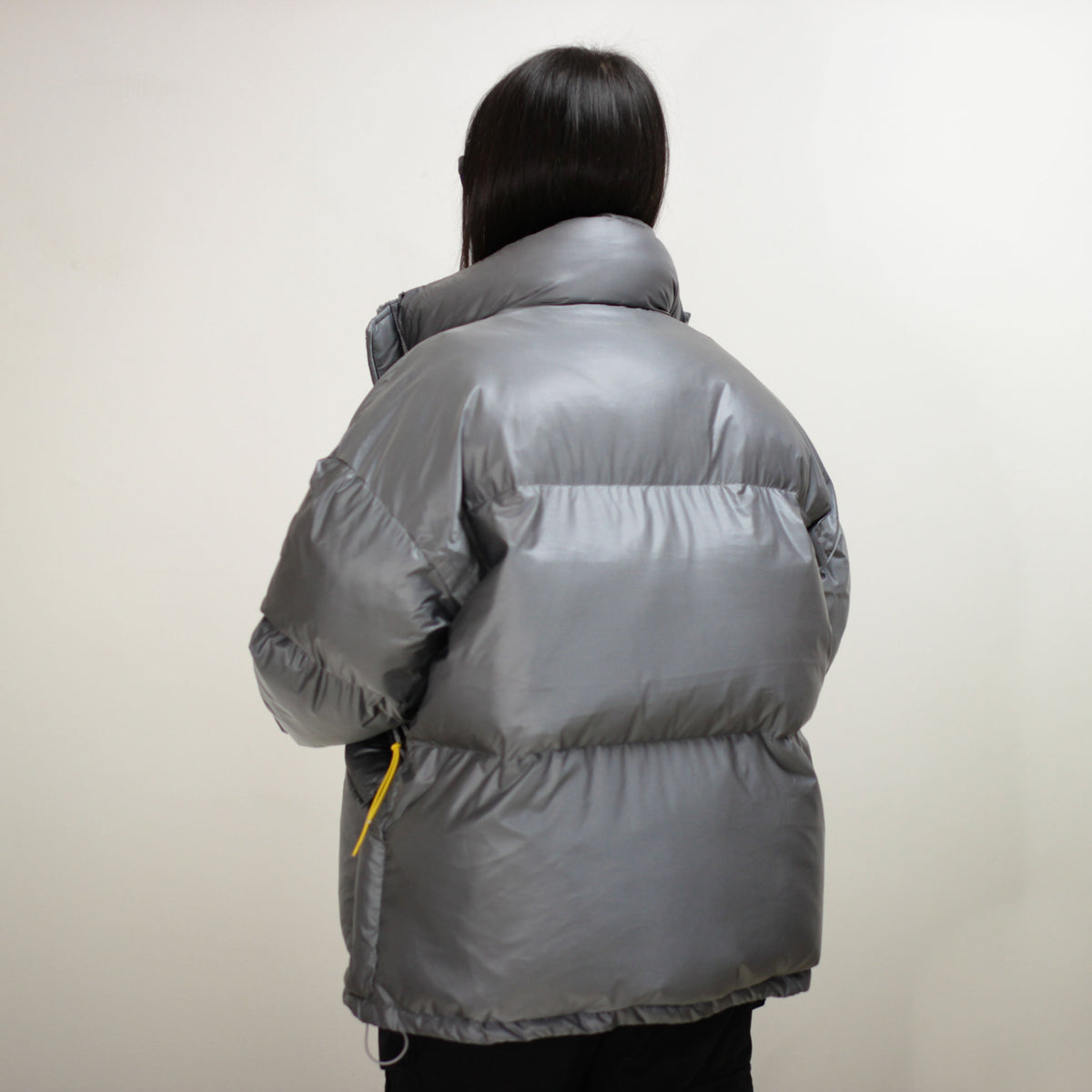 Gray padded round jacket with high collar, viewed from the back.