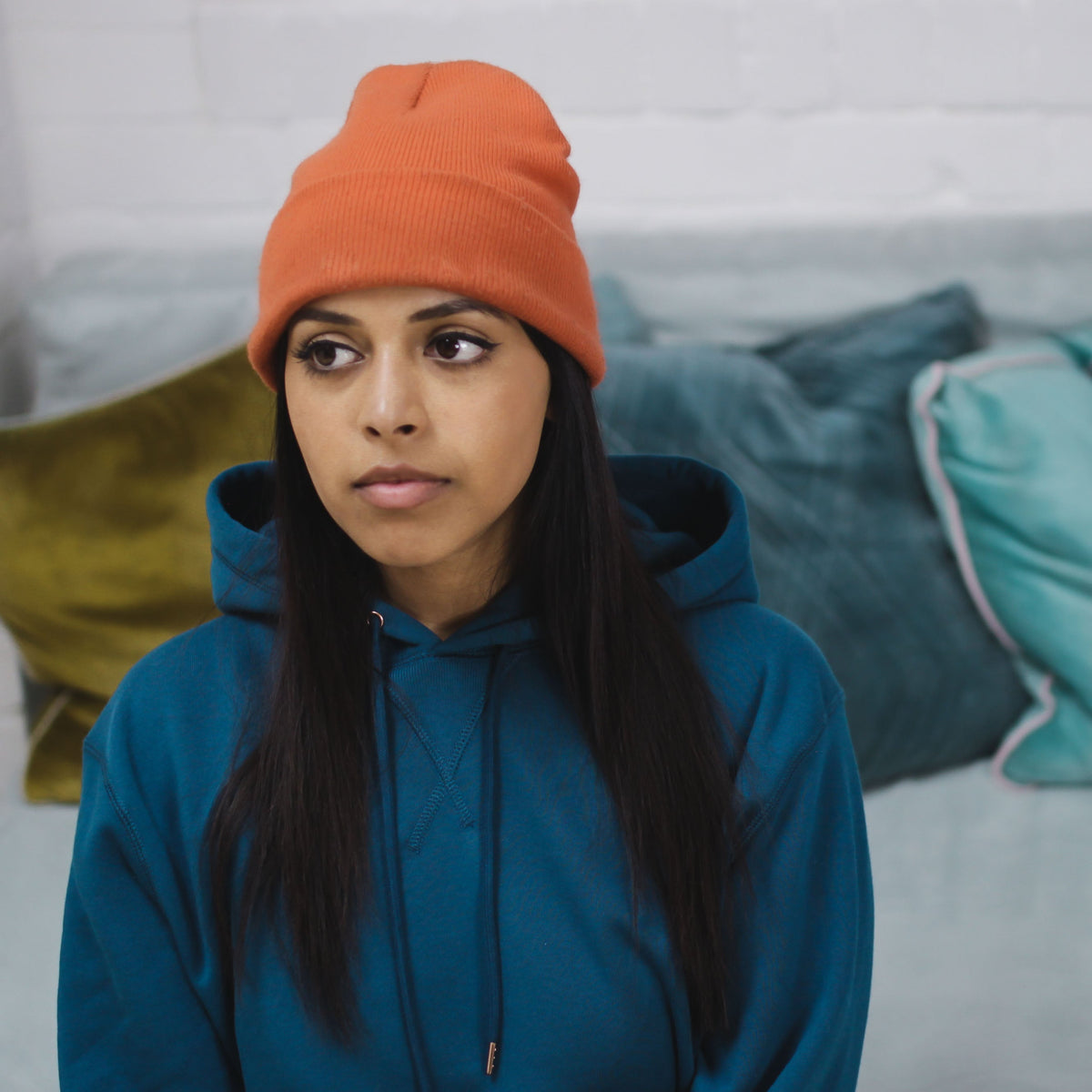 Sapphire Blue hoodie worn by a person indoors.