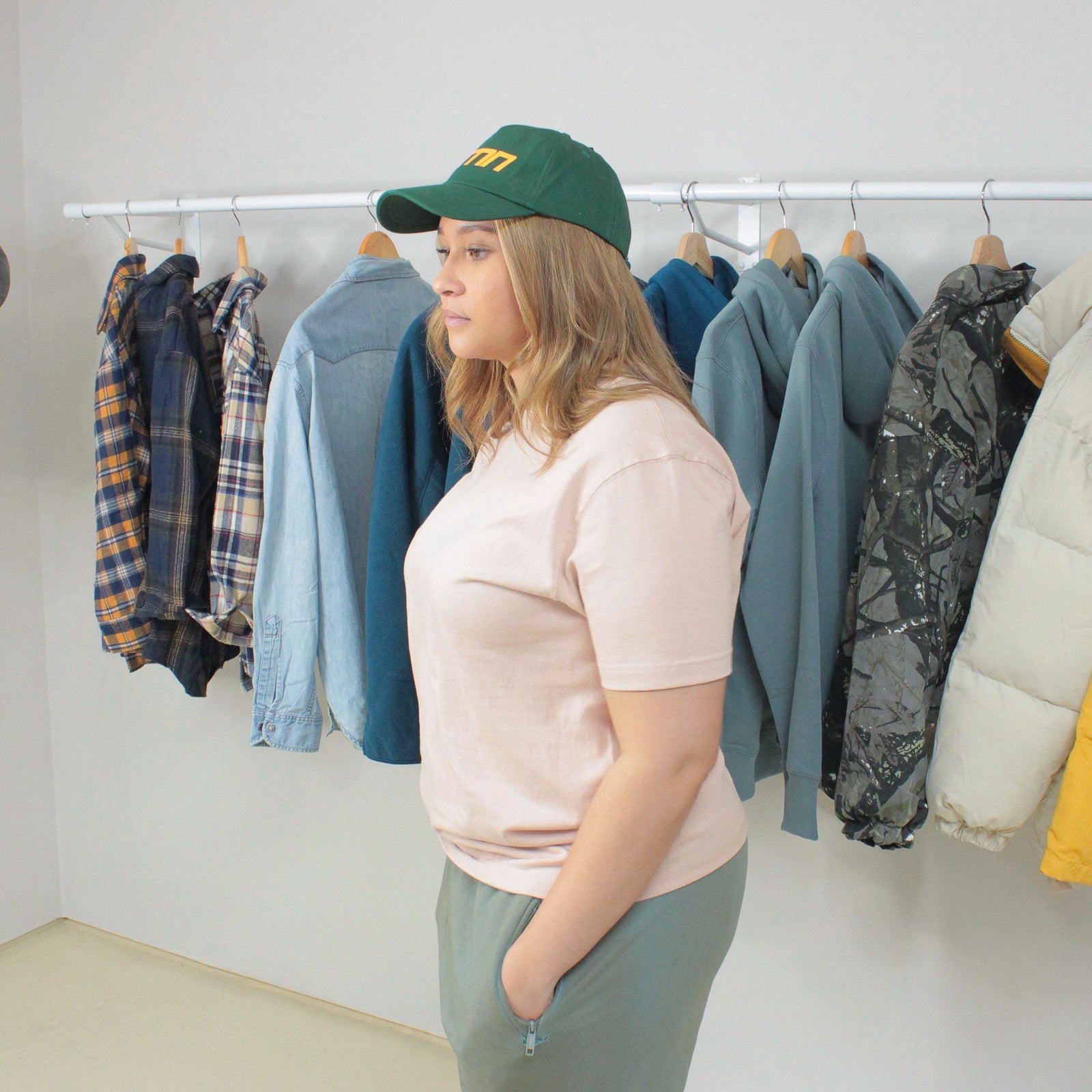 Woman wearing Peach Winter Tee in a clothing store.