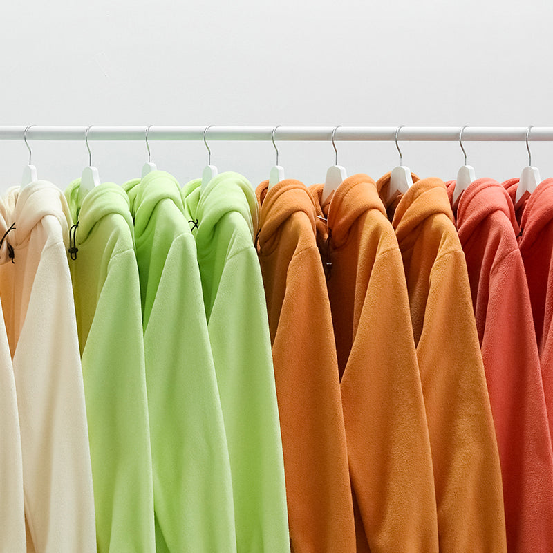 Cozy Peach Hoodie on rack with various colors.