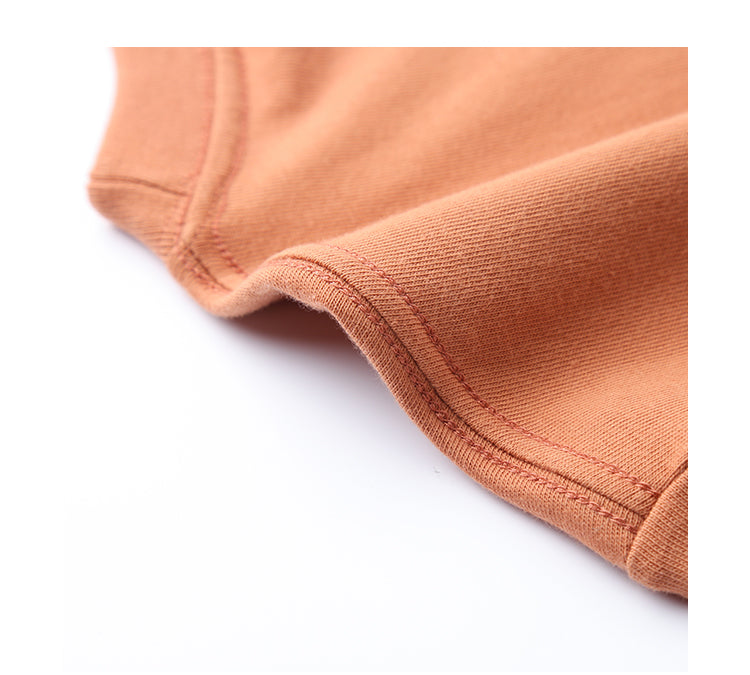 Rust Tee fabric close-up showing seamless stitching.