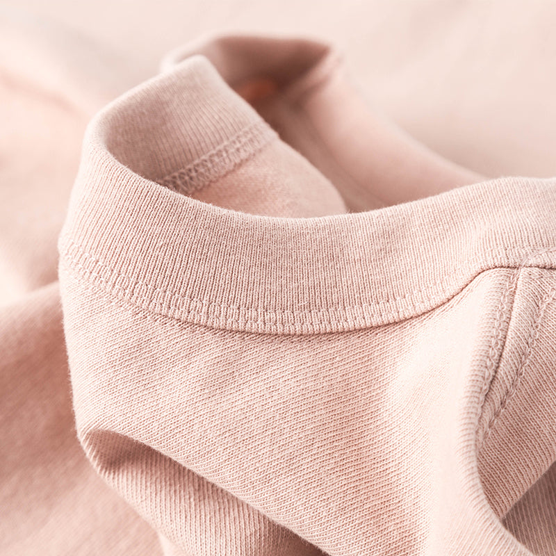 Peach Winter Tee in soft peach fabric close-up.