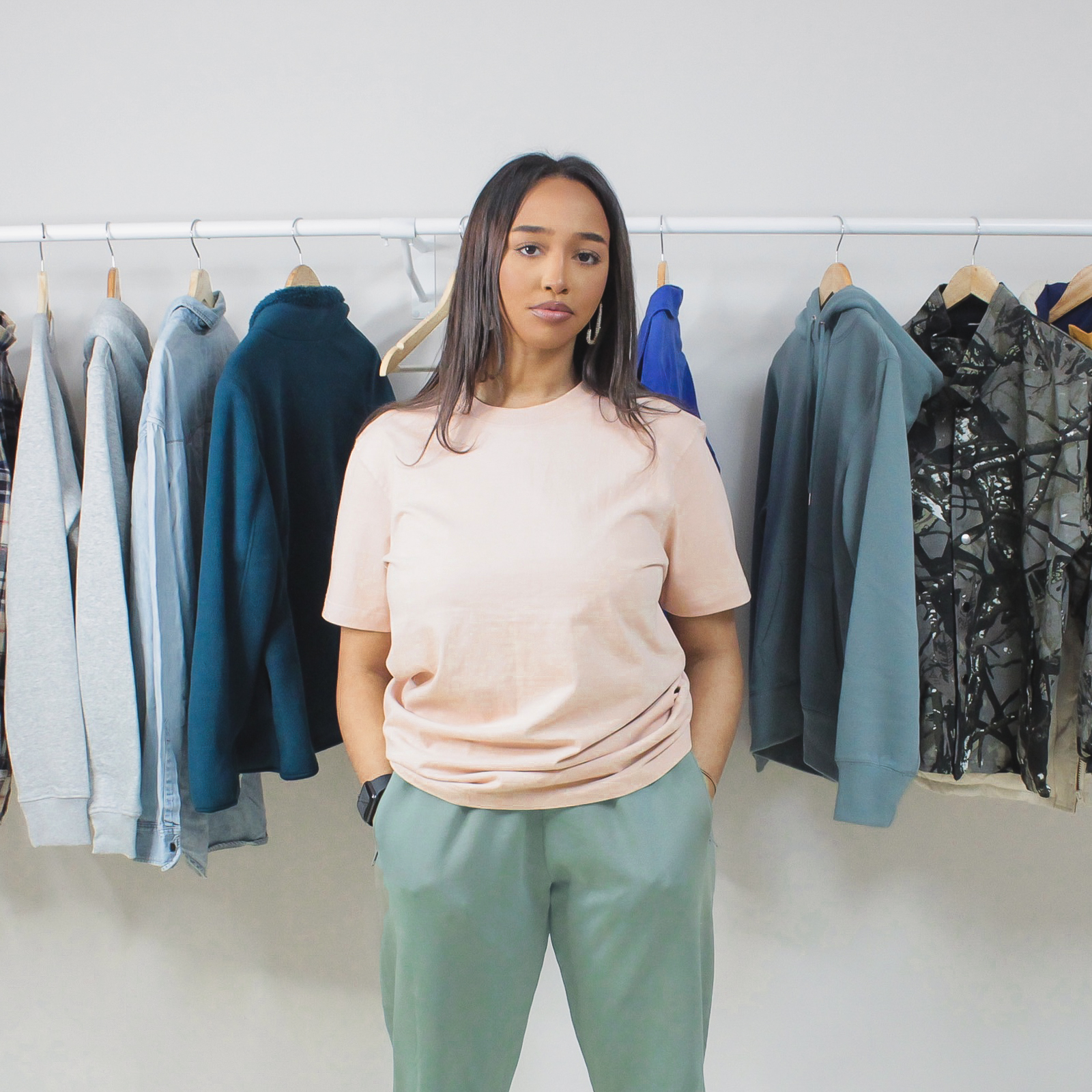 Aqua Premium Jogger Pants displayed on a woman with a casual outfit in a clothing store.