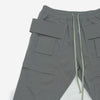 gray cargo trousers laid on white background long grey drawstring to tighten waist, close-up multiple pockets nylon material