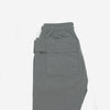gray cargo trousers laid on white background side pockets and waist strap across