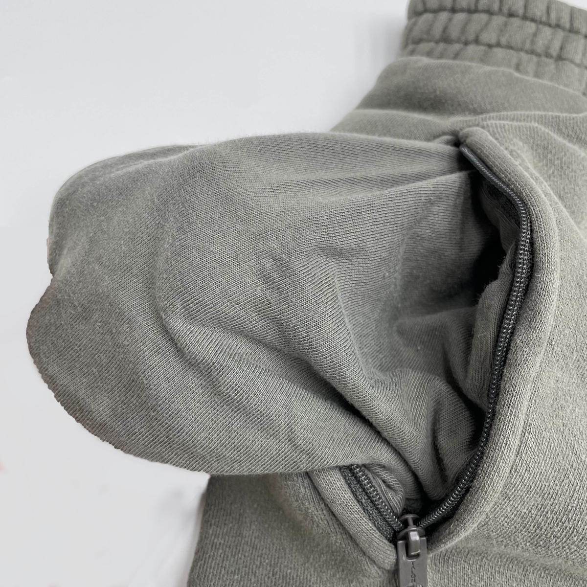 Light gray premium jogger with zippered pocket detail.